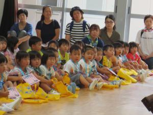 太鼓の演奏を真剣に聞いている子供たちの写真